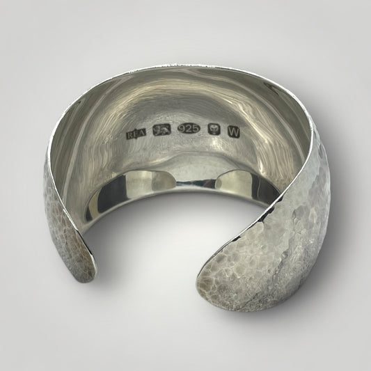 Hammered cuff bangle in Argentium Silver with large UK display hallmark.