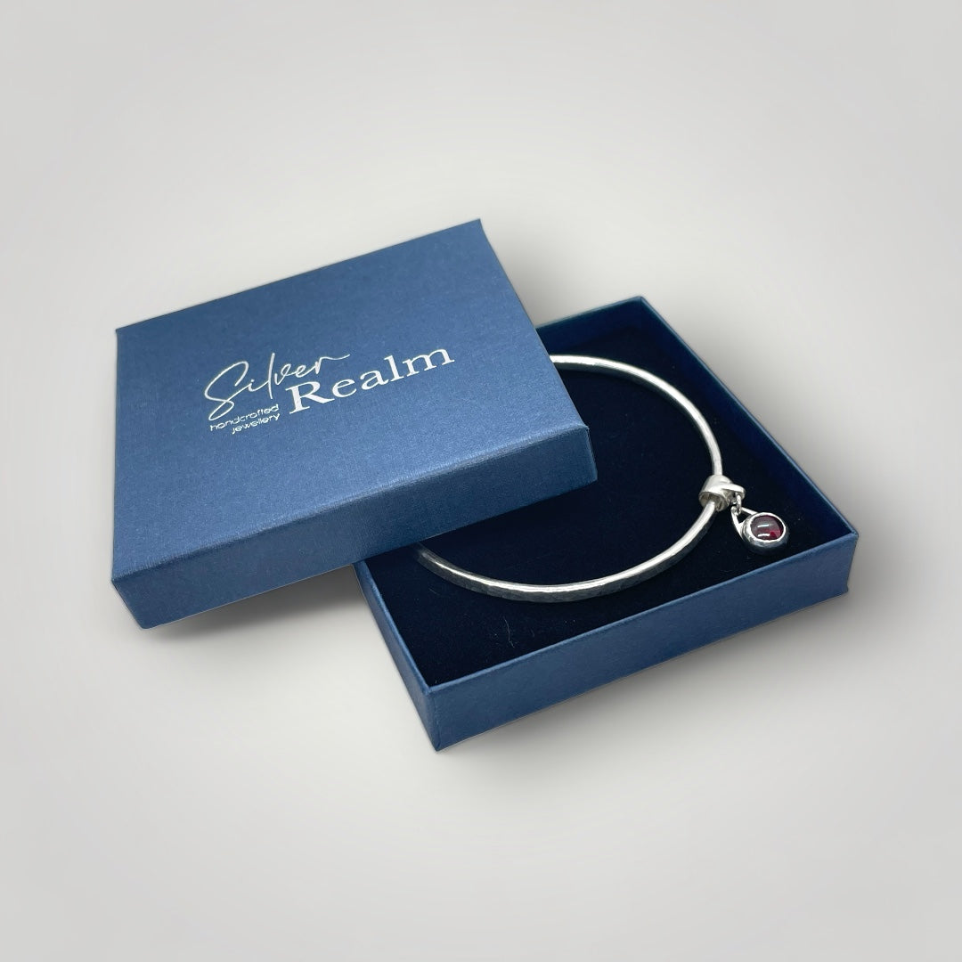 Garnet charm bangle in sterling silver - other gemstones available on request.