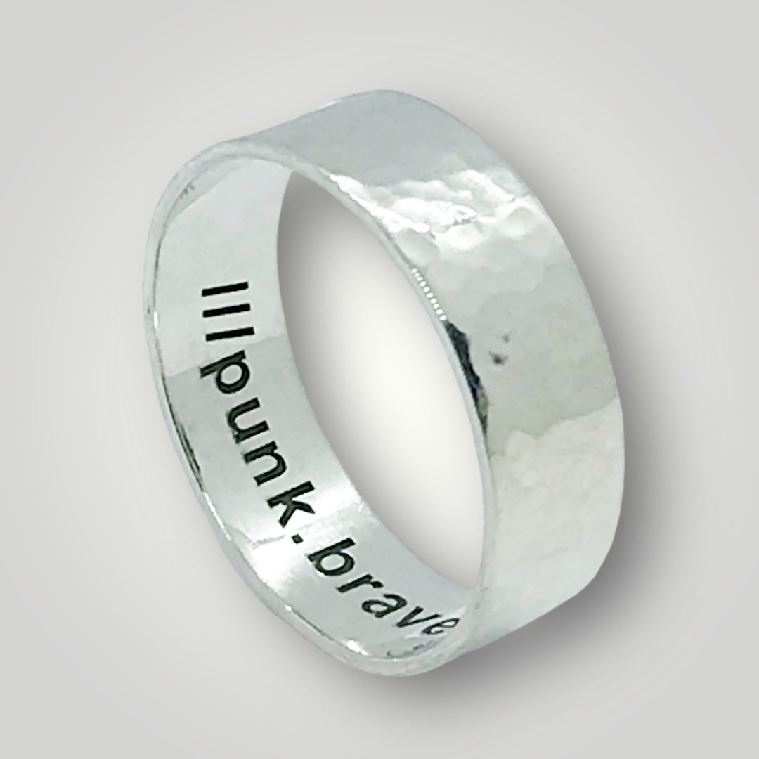 A wide, hammered, sterling silver band with your choice of what3words address laser engraved around the inside of the ring