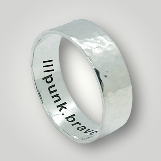 A wide, hammered, sterling silver band with your choice of what3words address laser engraved around the inside of the ring