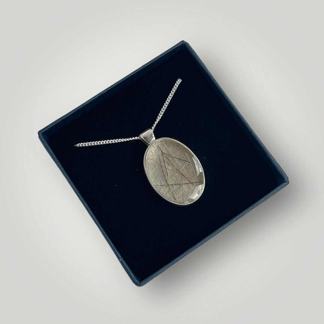 A sterling silver pendant filled with resin containing the customers horse hair on a sterling silver chain