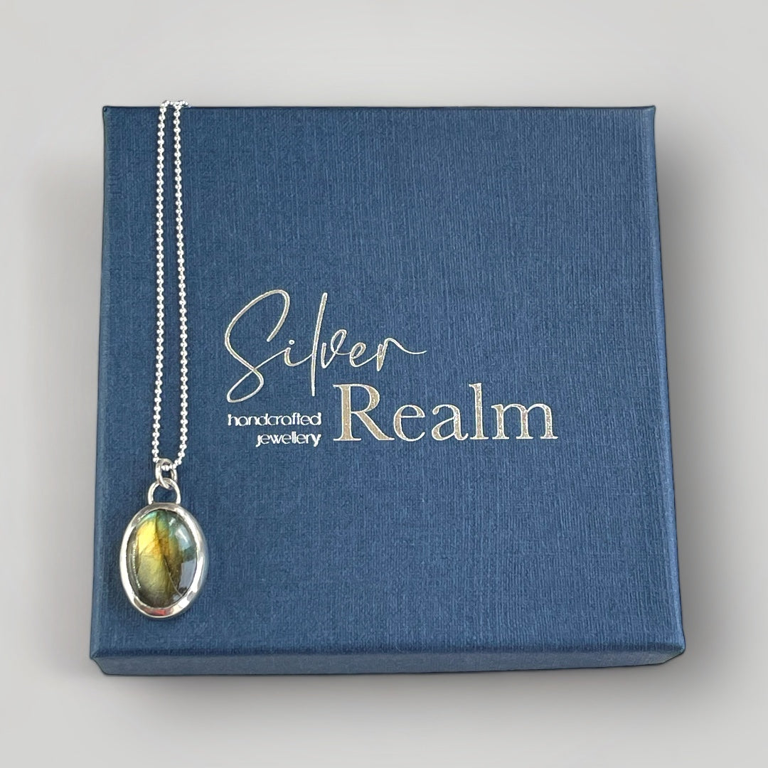 A sterling silver pendant set with an oval Labradorite on a sterling silver chain