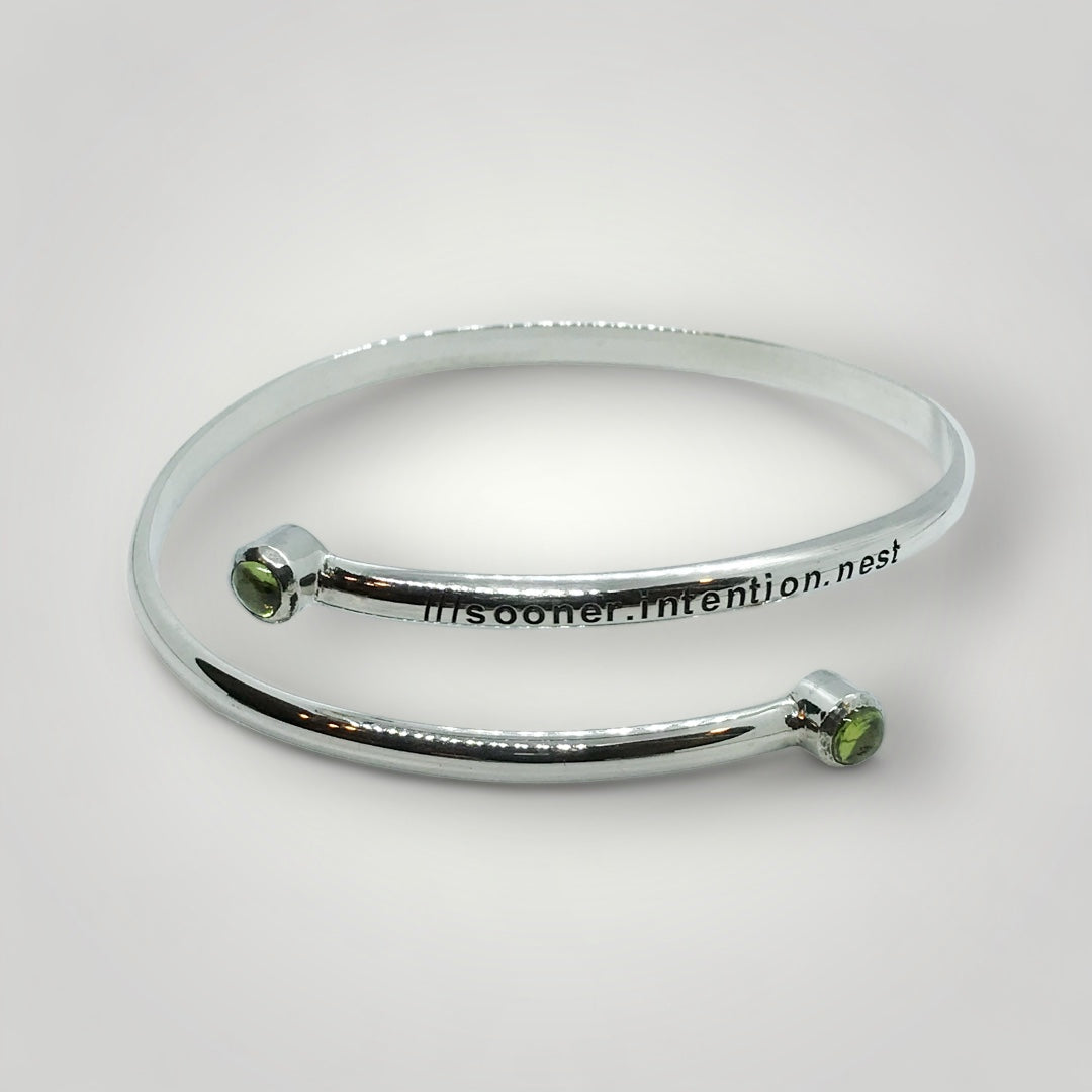 Adjustable sterling silver bangle with two Peridot and engraved with a what3words address of your choice