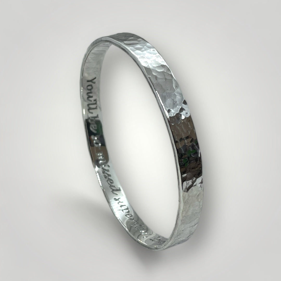 A wide sterling silver bangle with a hammered finish. Option to personalise inside of bangle with an engraved message.