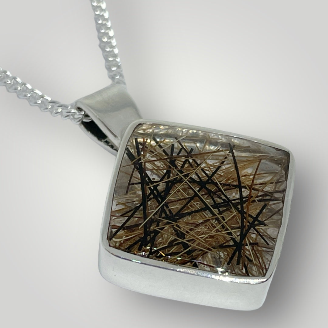 A sterling silver pendant filled with resin containing the customers horse hair on a sterling silver chain
