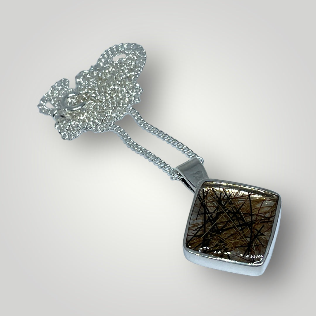 A sterling silver pendant filled with resin containing the customers horse hair on a sterling silver chain