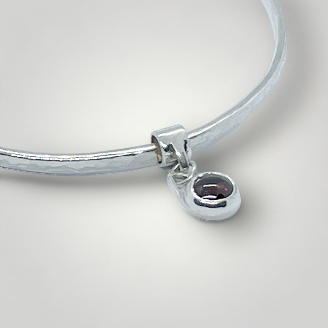 Garnet charm bangle in sterling silver - other gemstones available on request.