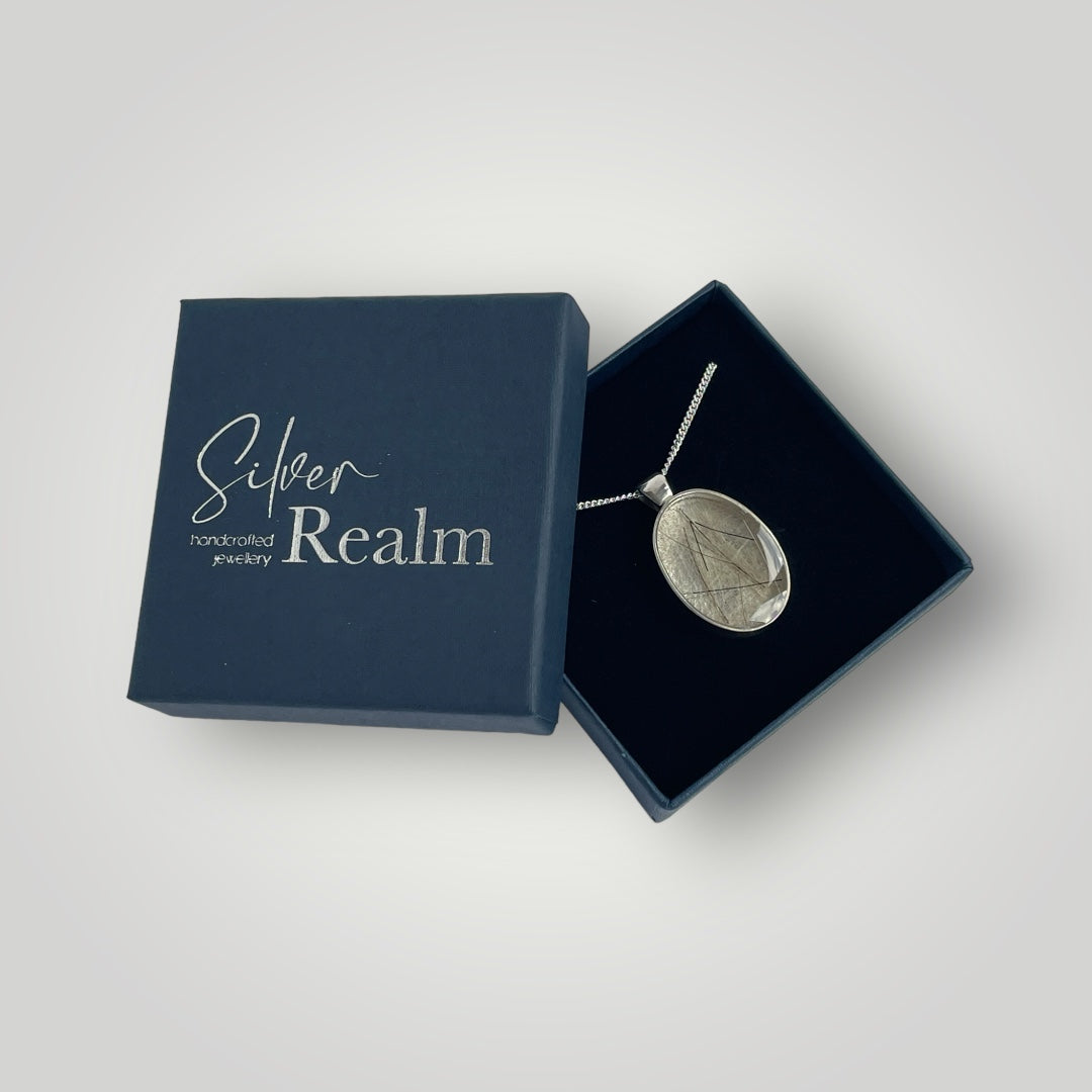A sterling silver pendant filled with resin containing the customers horse hair on a sterling silver chain