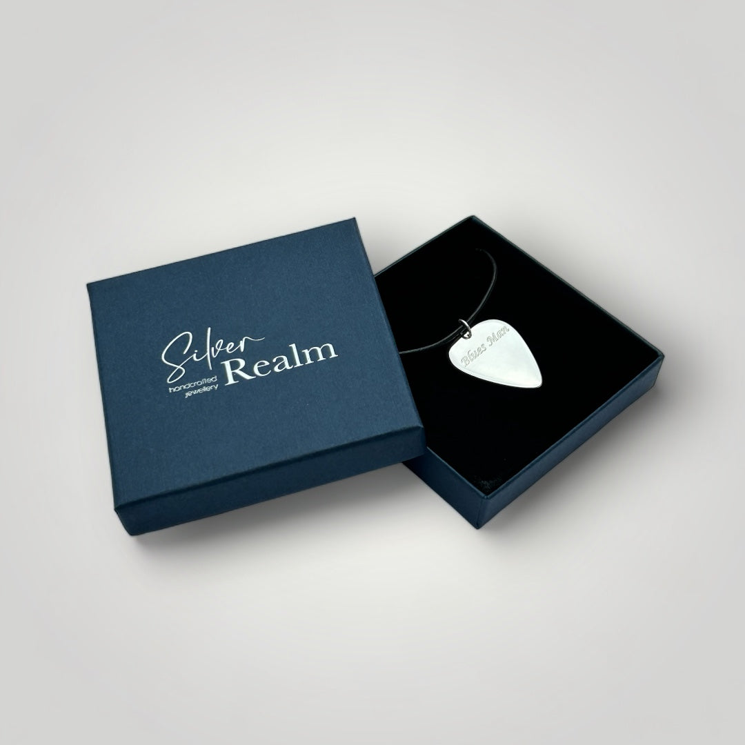 Silver guitar pick necklace on leather cord in gift box.