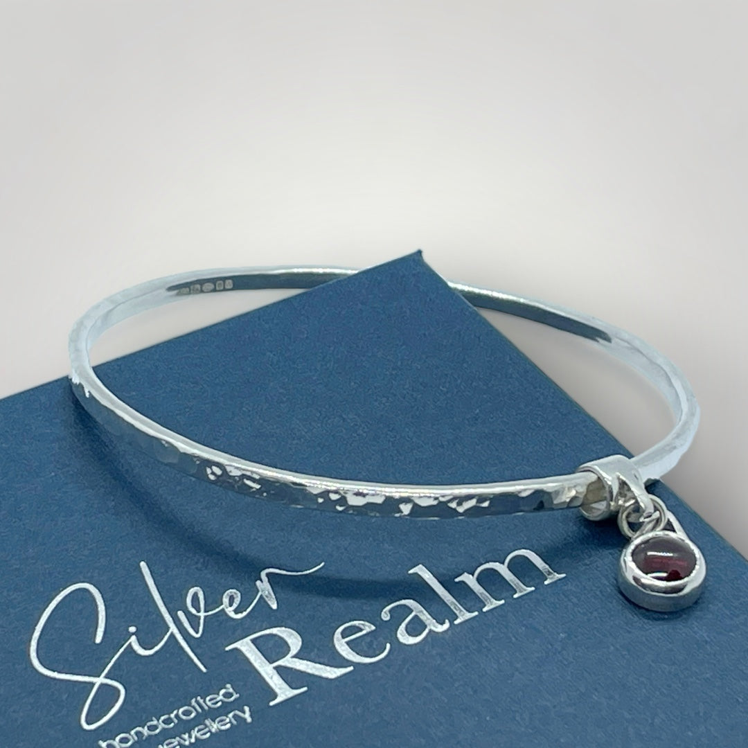 Garnet charm bangle in sterling silver - other gemstones available on request.