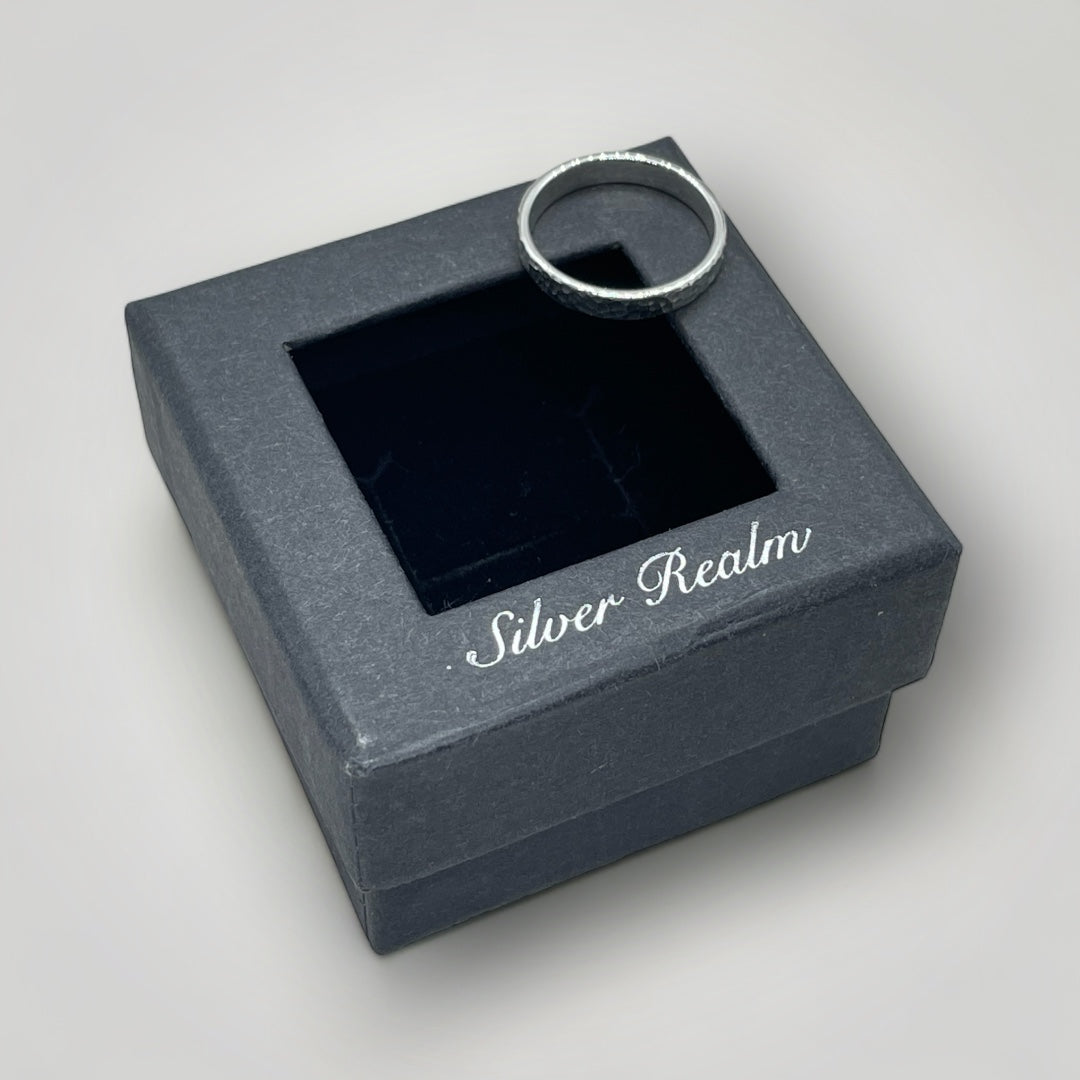 A textured, sterling silver ring