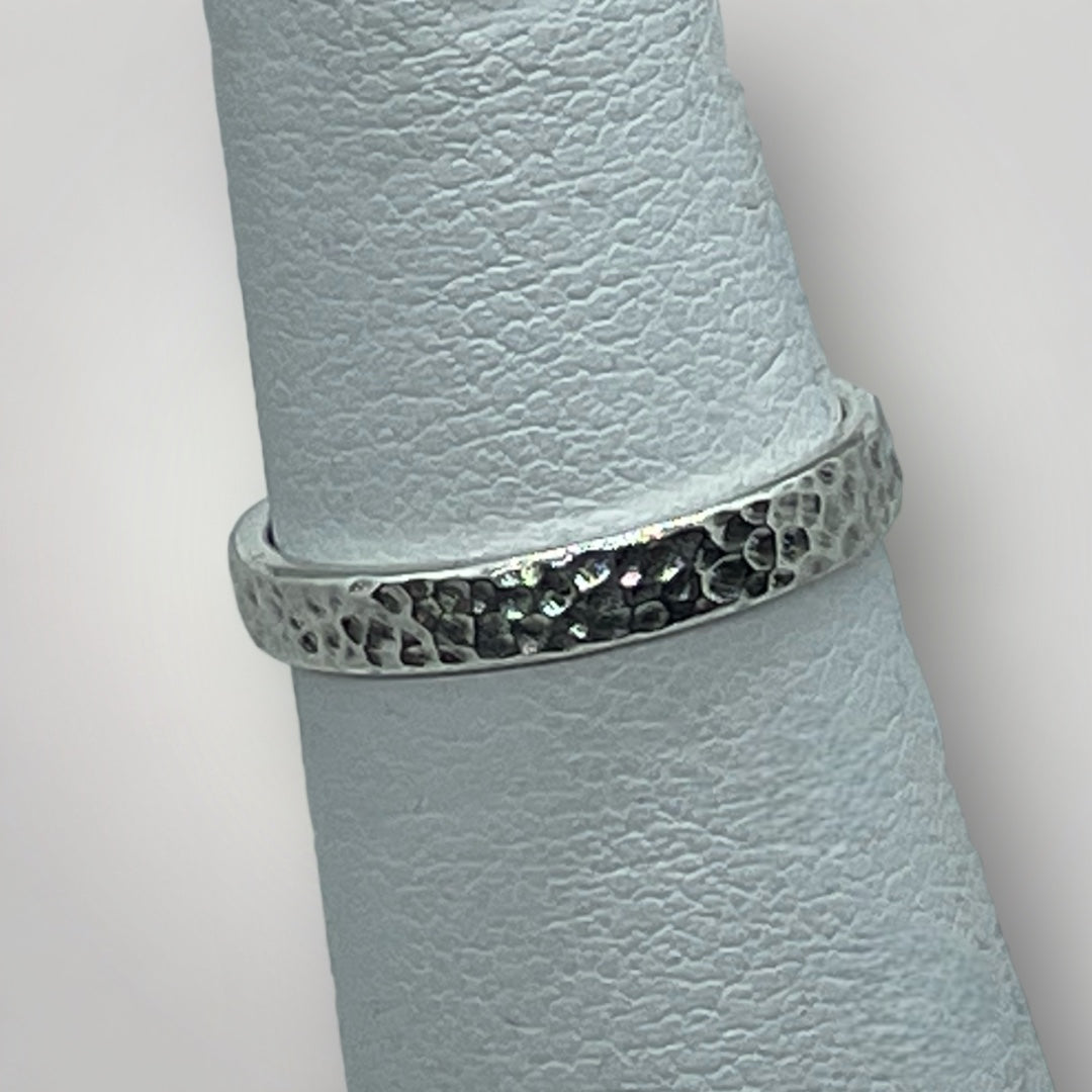 A textured, sterling silver ring