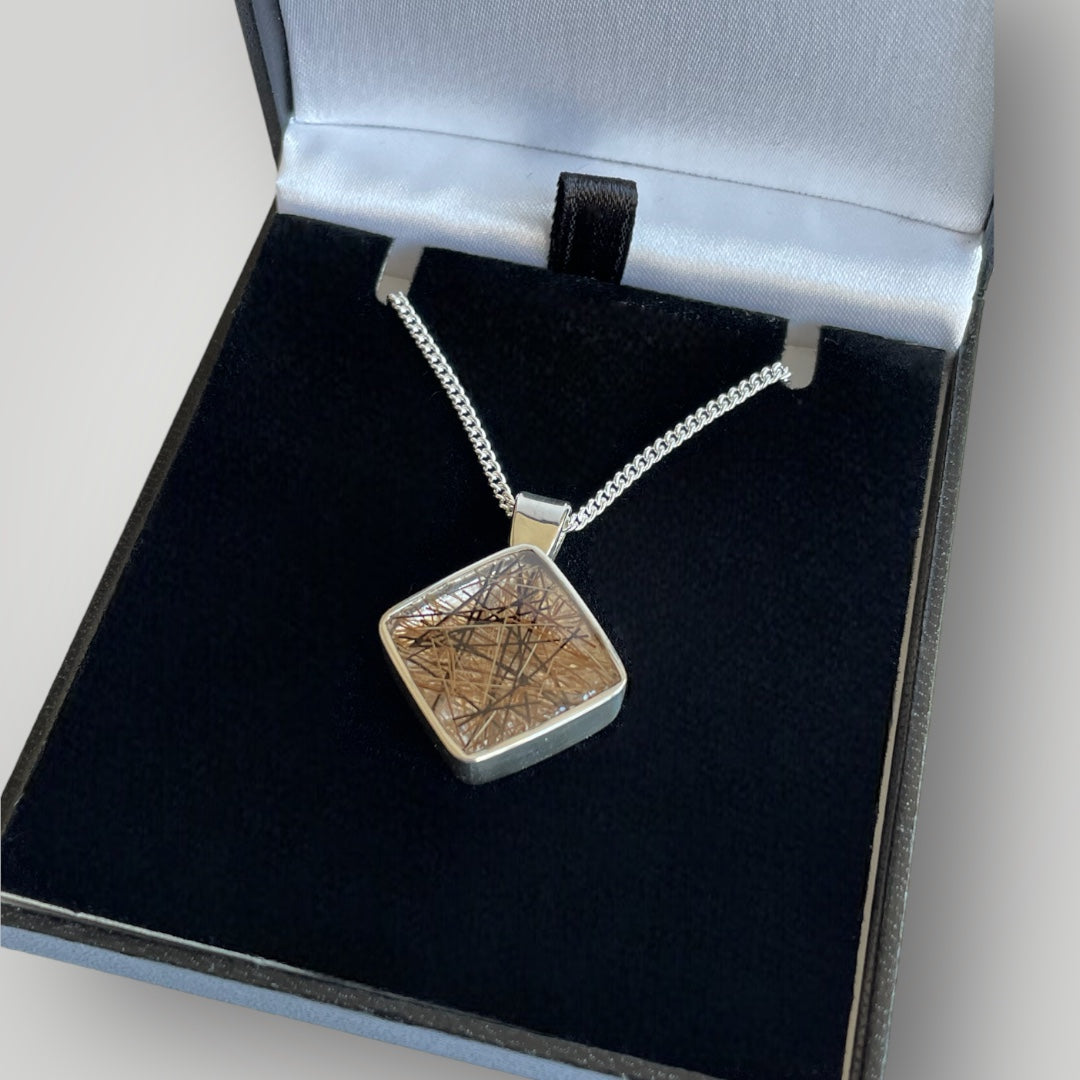 A sterling silver pendant filled with resin containing the customers horse hair on a sterling silver chain