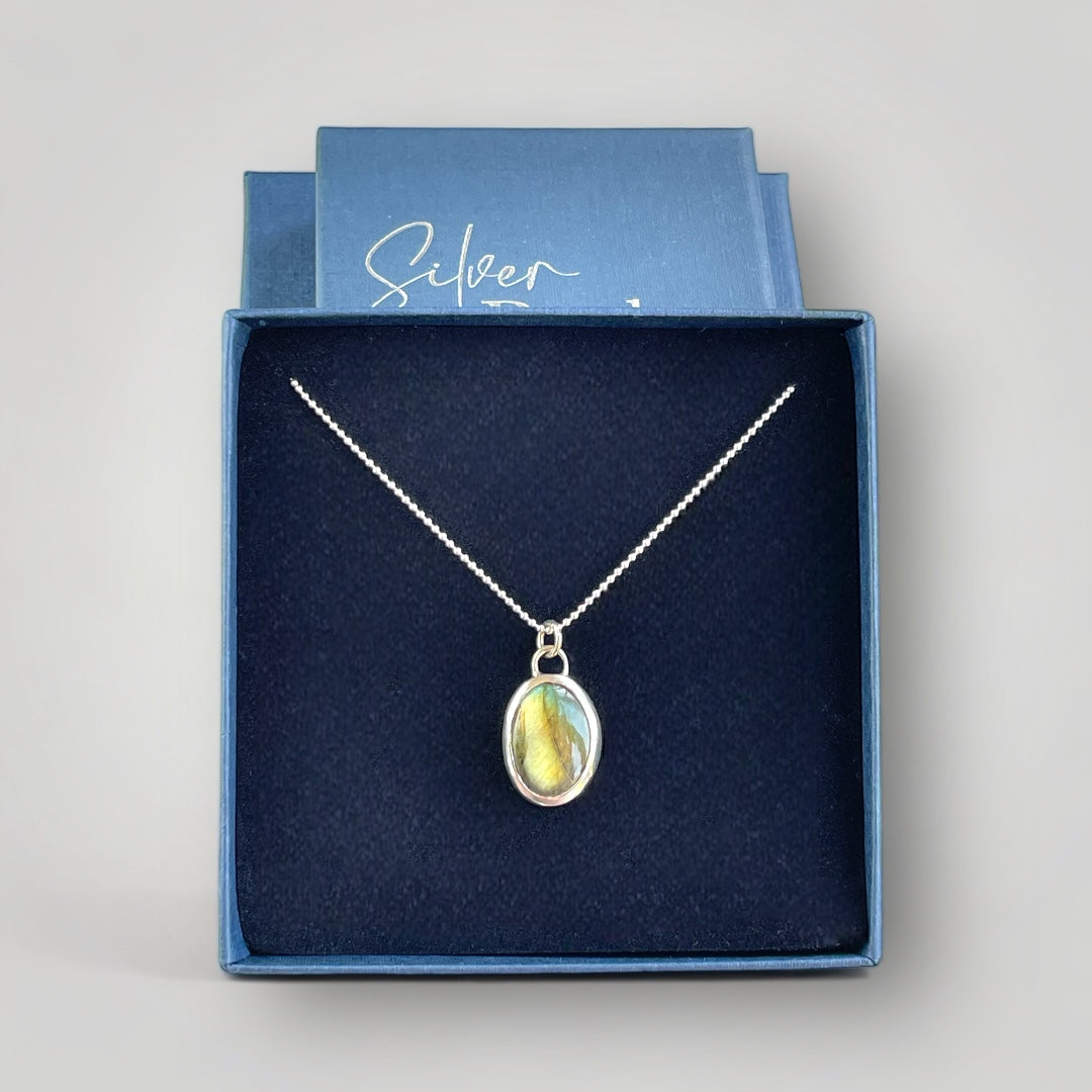 A sterling silver pendant set with an oval Labradorite on a sterling silver chain