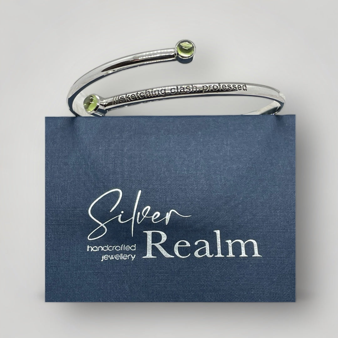 Adjustable sterling silver bangle with two Peridot and engraved with a what3words address of your choice