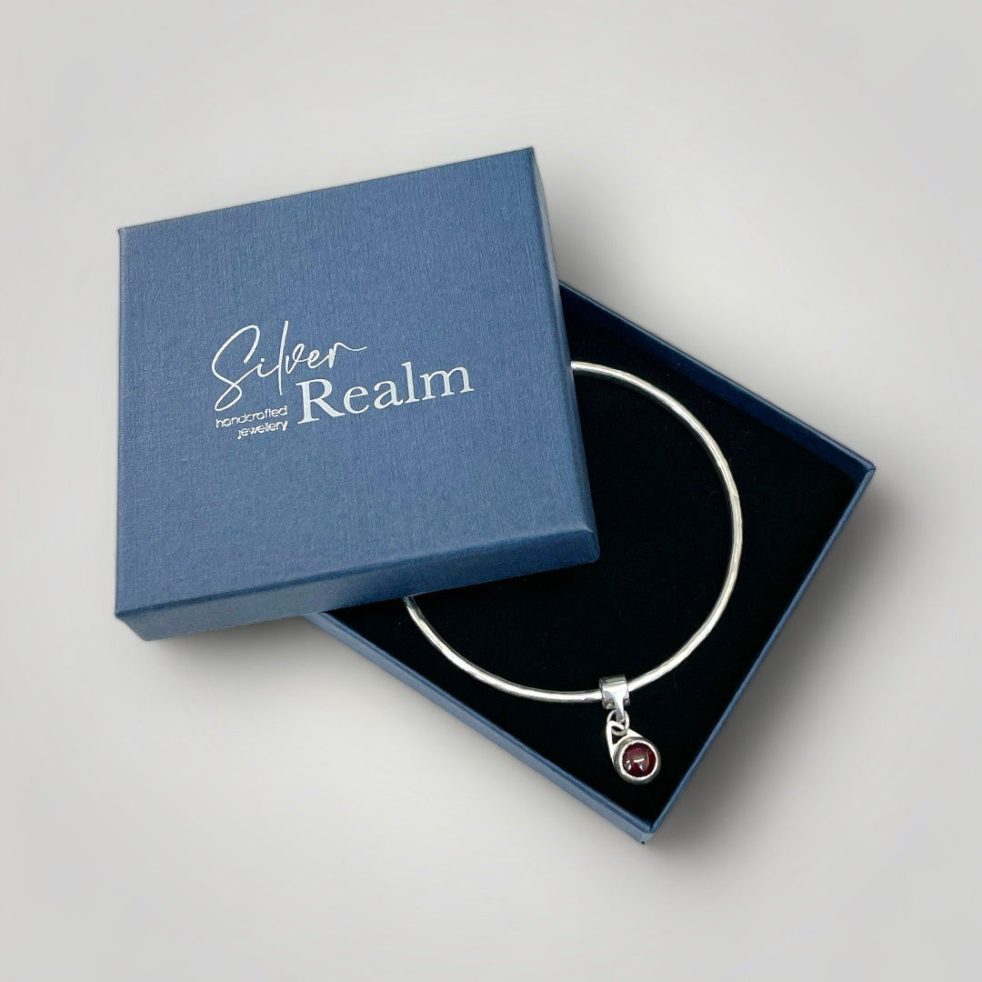 Garnet charm bangle in sterling silver - other gemstones available on request.