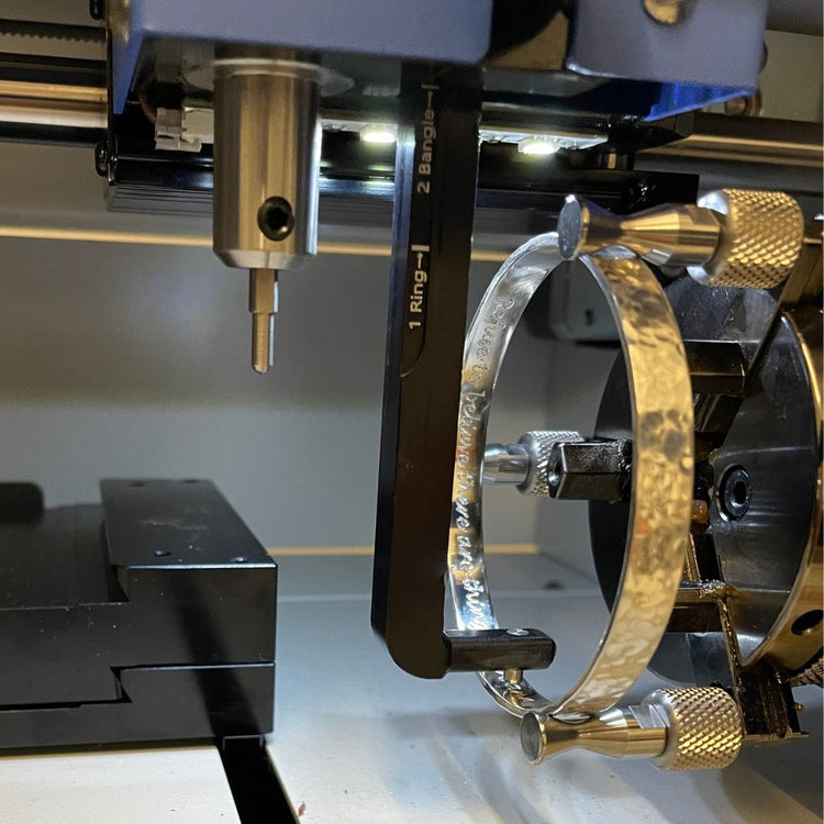 Personalised silver bangle being engraved in the Silver Realm workshop