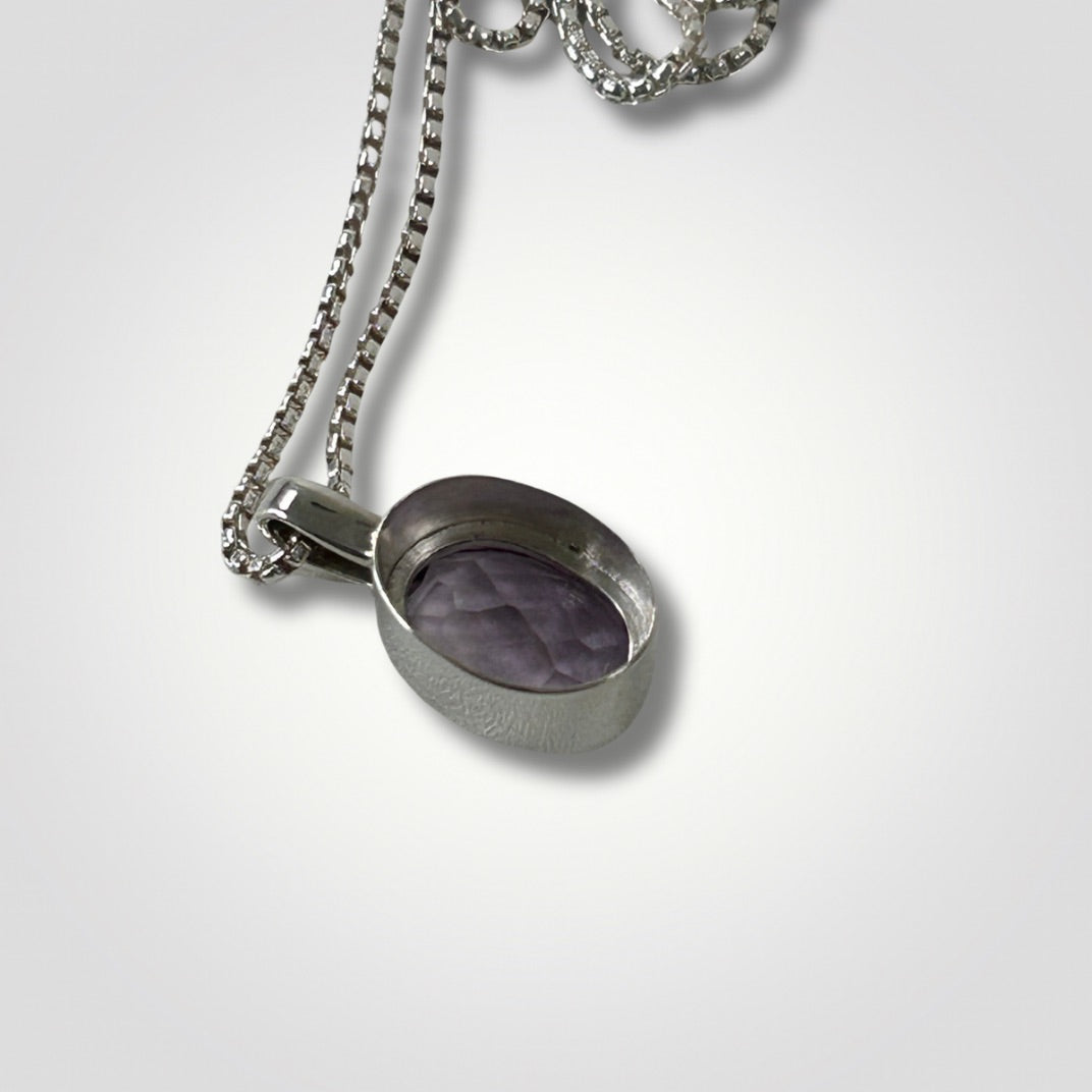 Reverse side of a faceted amethyst sterling silver pendant necklace on an 18 inch box chain
