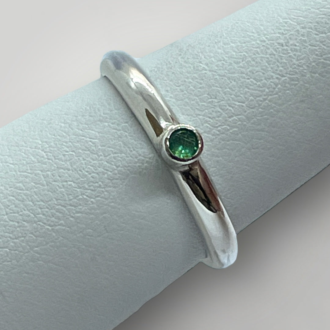Top view of a sterling silver and Emerald stacking ring