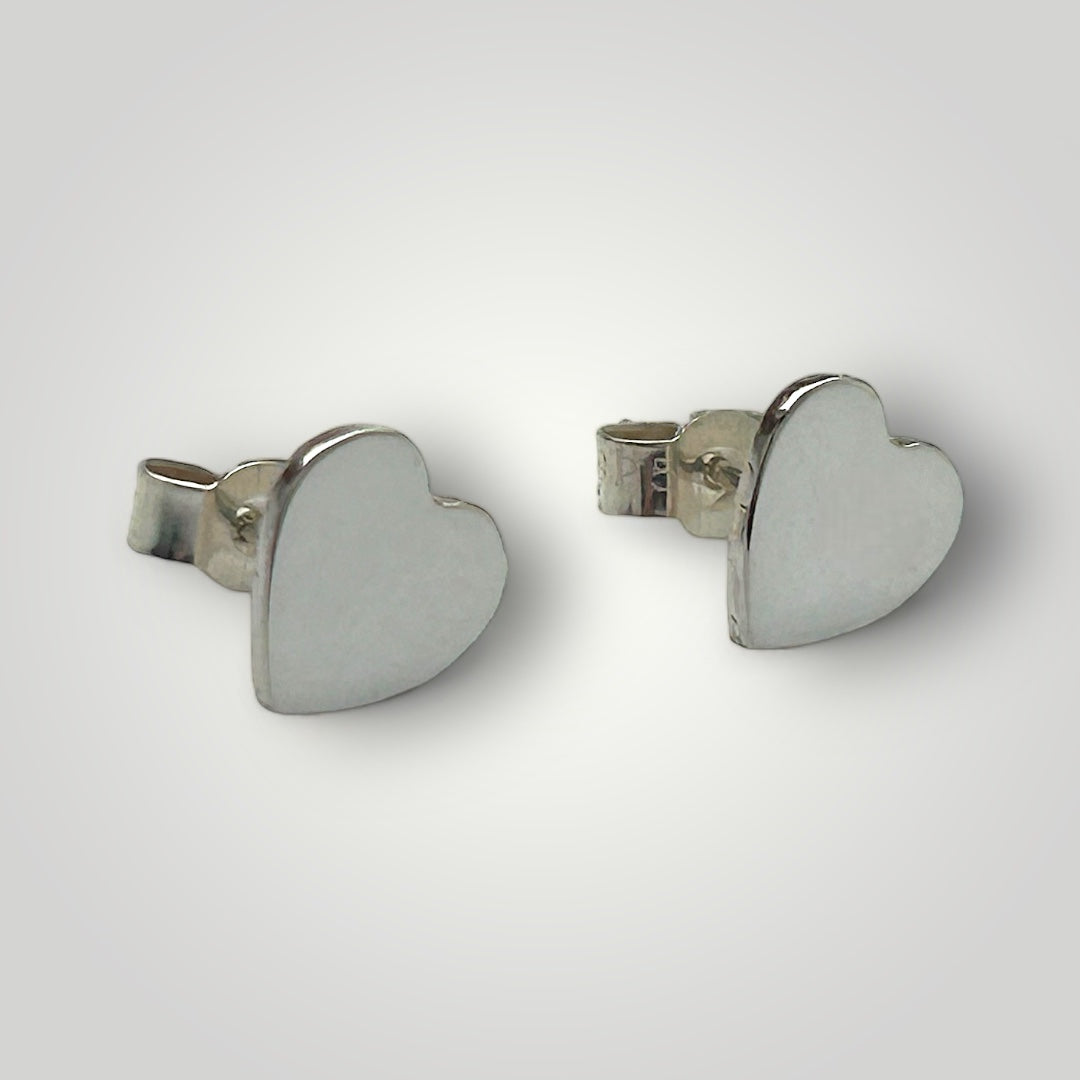 Sterling silver heart shape stud earrings with butterfly closure.