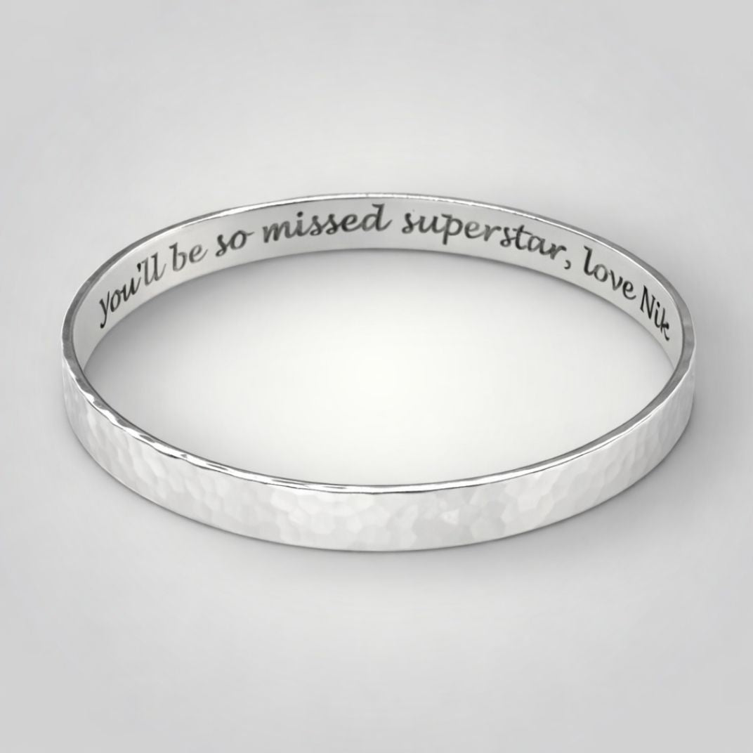 Personalised hammered sterling silver bangle showing engraved message on the inside