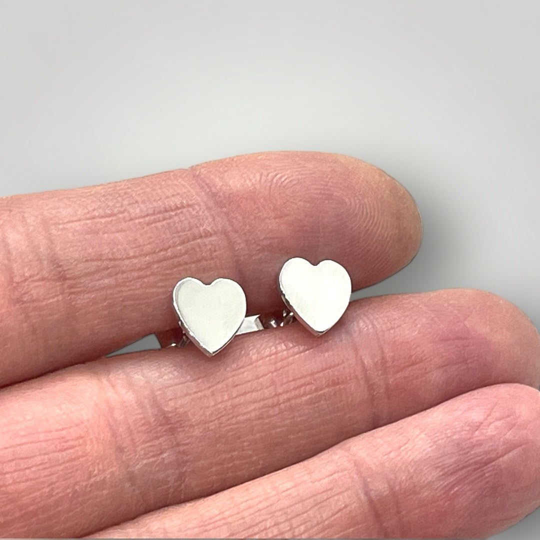 Sterling silver heart shape stud earrings with butterfly closure.