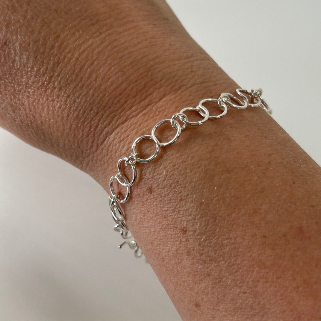 Sterling silver circle link bracelet worn on the wrist