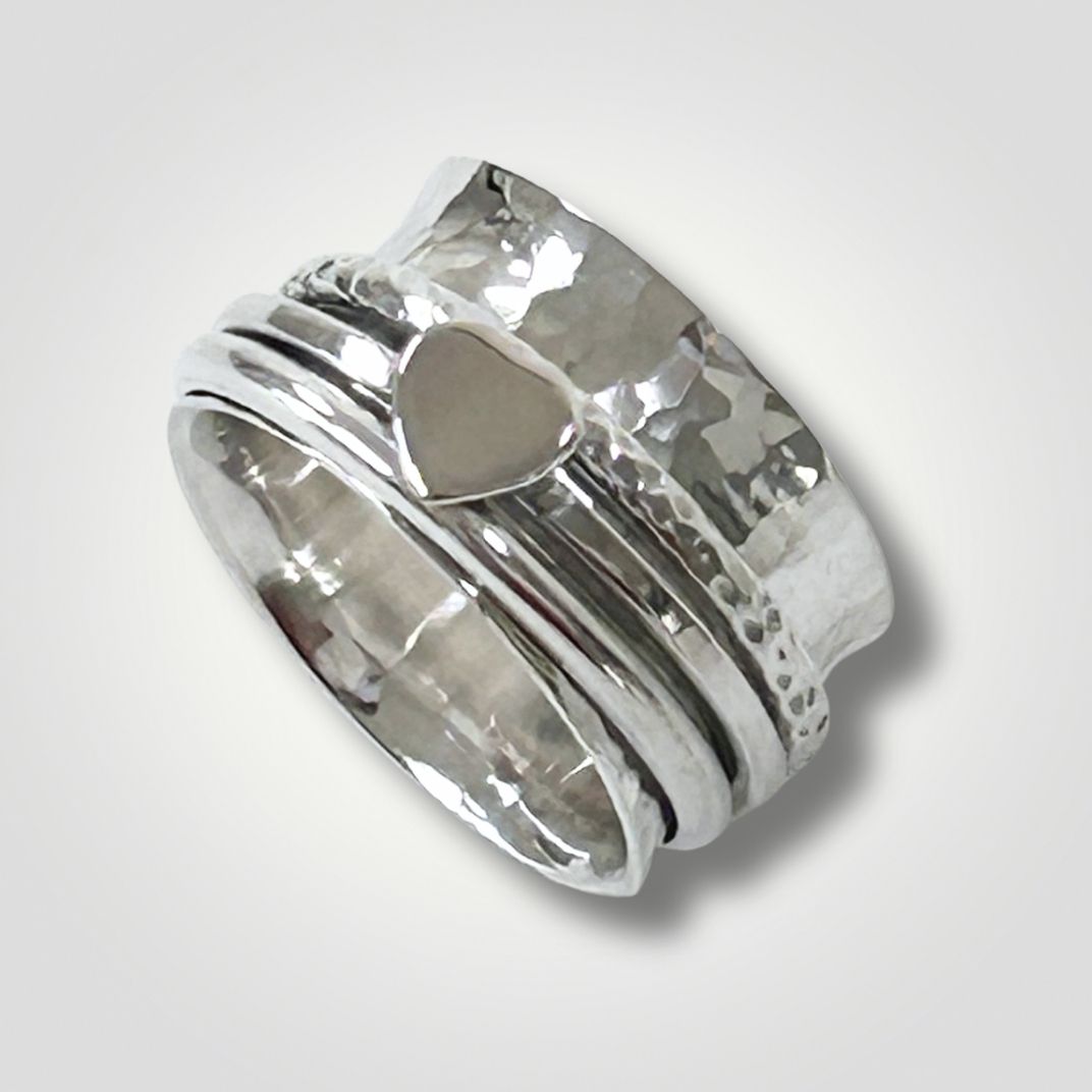 Handmade sterling silver hammered spinner ring with heart detail