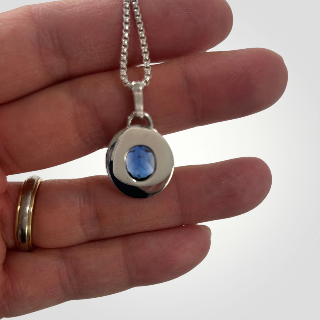 Reverse side of synthetic sapphire and silver handmade pendant

