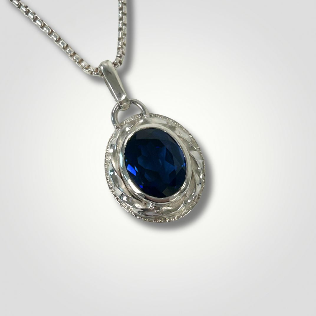 Synthetic sapphire silver pendant with textured handmade setting