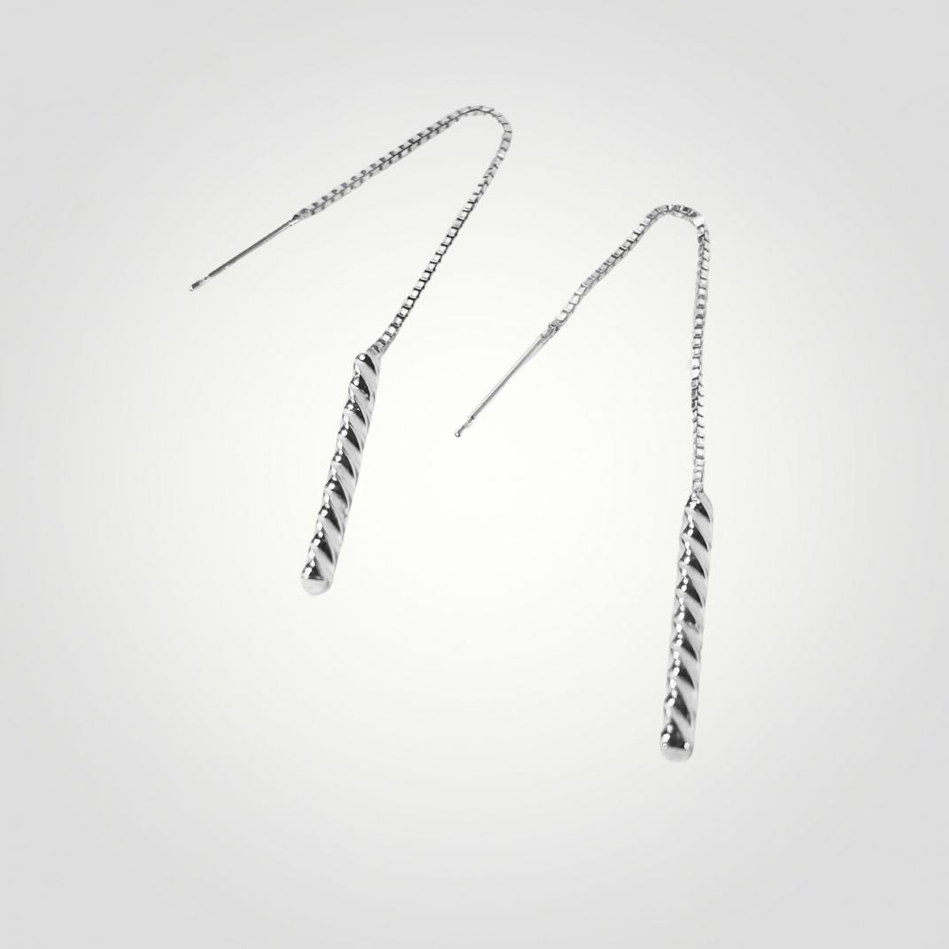 Pair of silver threader earrings on a light gray background