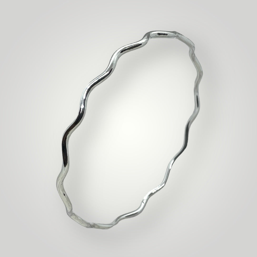 A wavy, solid, sterling silver bangle.