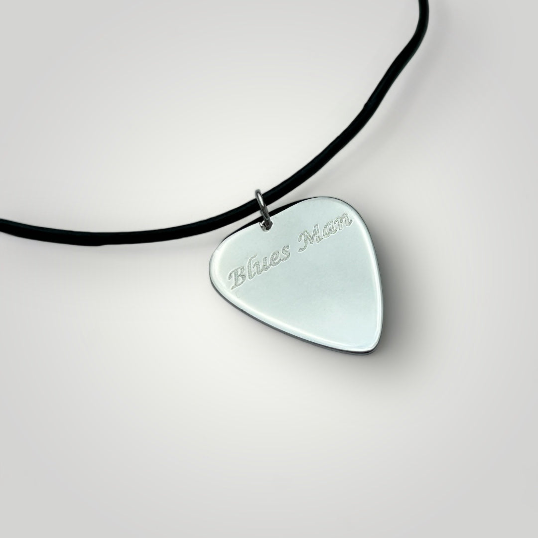 Silver guitar pick necklace on leather cord.