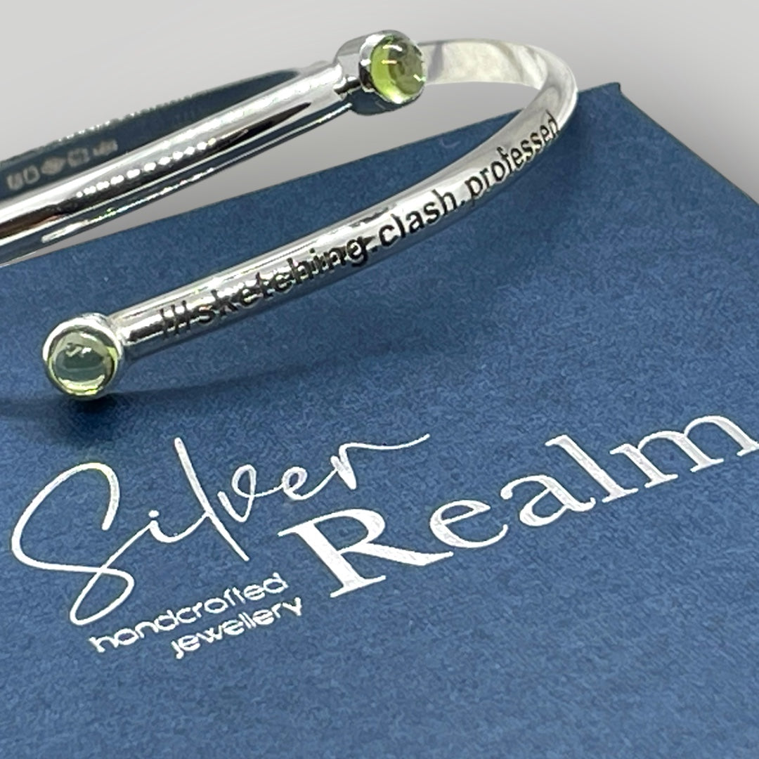 Adjustable sterling silver bangle with two Peridot and engraved with a what3words address of your choice