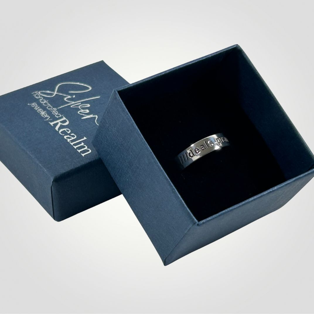 Sterling silver ring in an open blue jewellery box with 'Silver Realm Jewellery' branding.